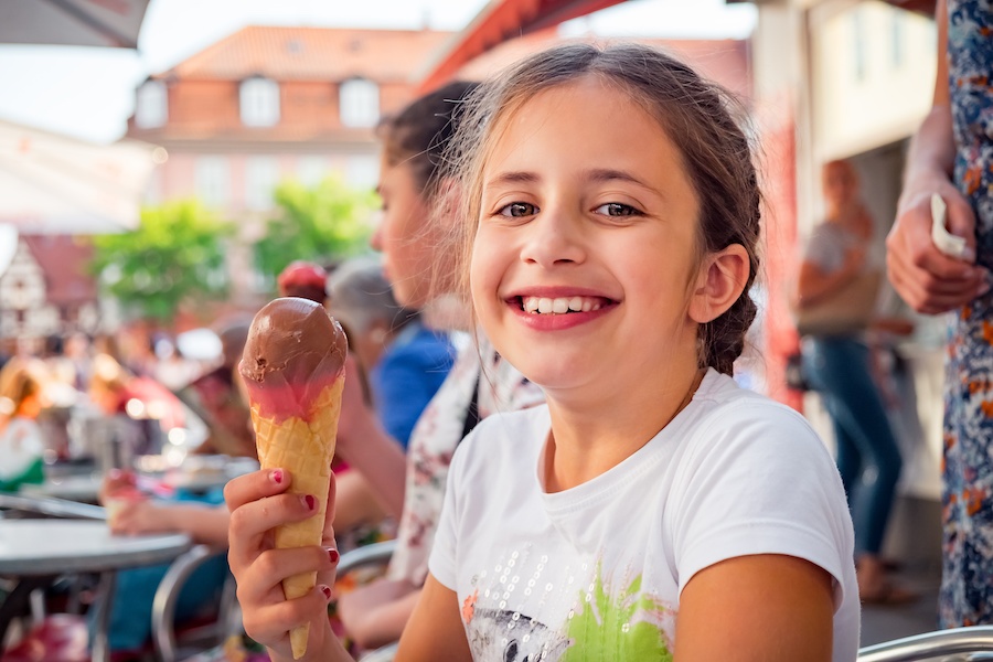 A little girl with a chocolate ice cream cone