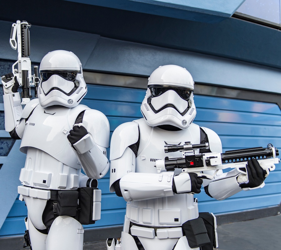 Two stormtroopers standing in front of a blue building