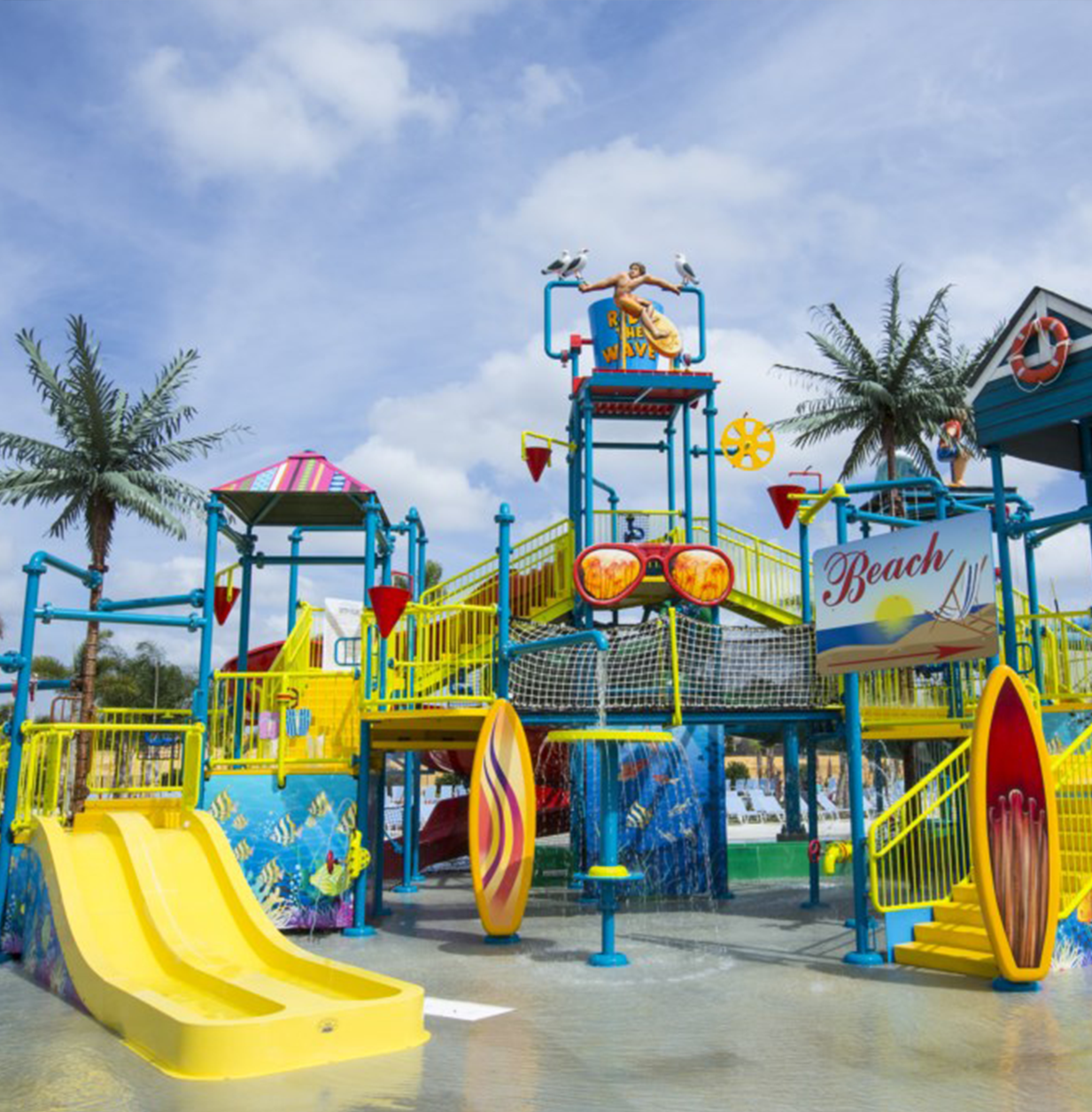 A waterpark with stairs, slides, bridges, sprinklers, and large buckets