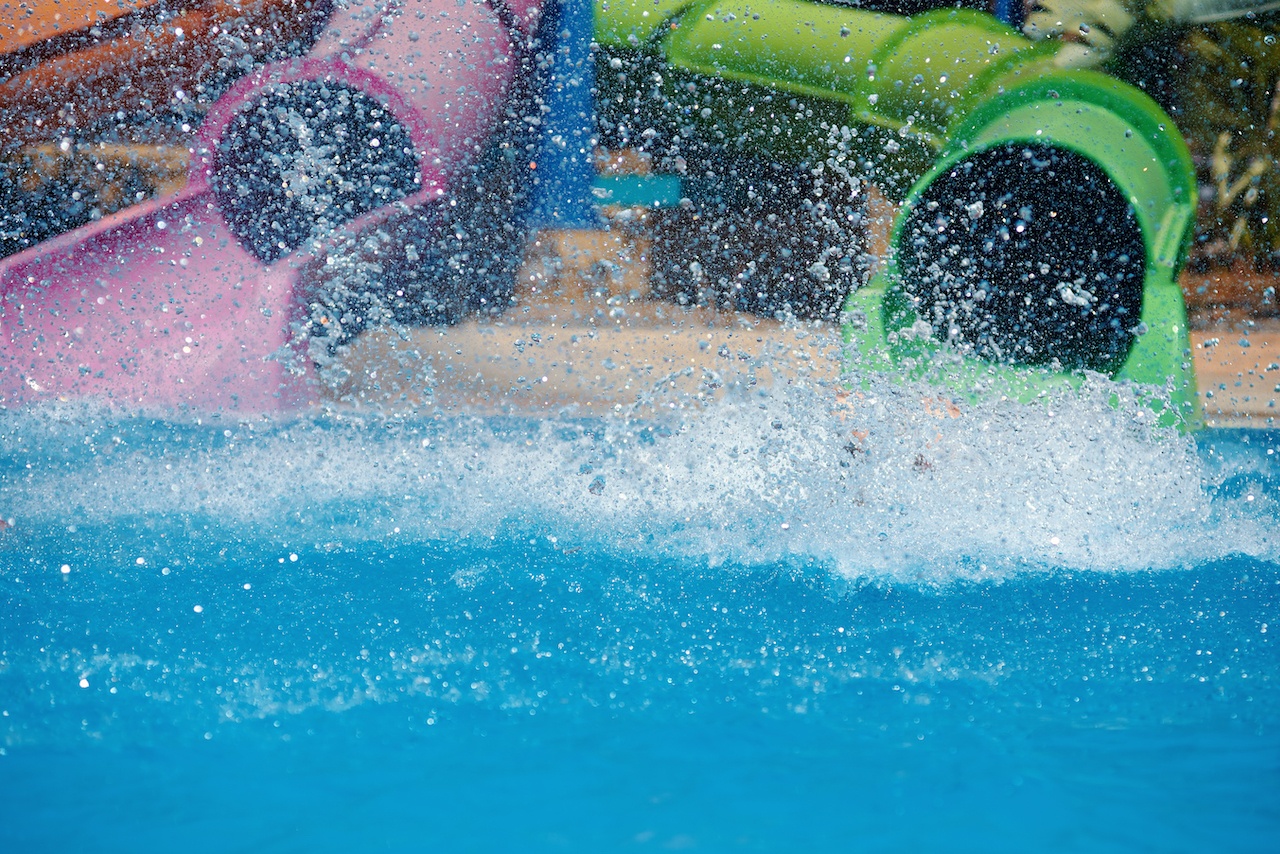 A close up of the bottom of two waterslides where you splash into the water