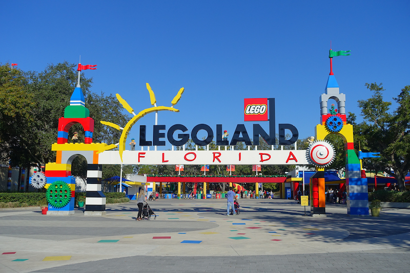 An image from the park with a logo in front that says "Legoland Florida". Two lego buildings are on either side of the logo.