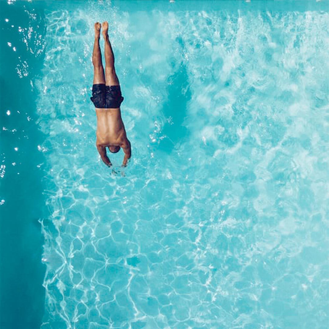 man diving into a pool